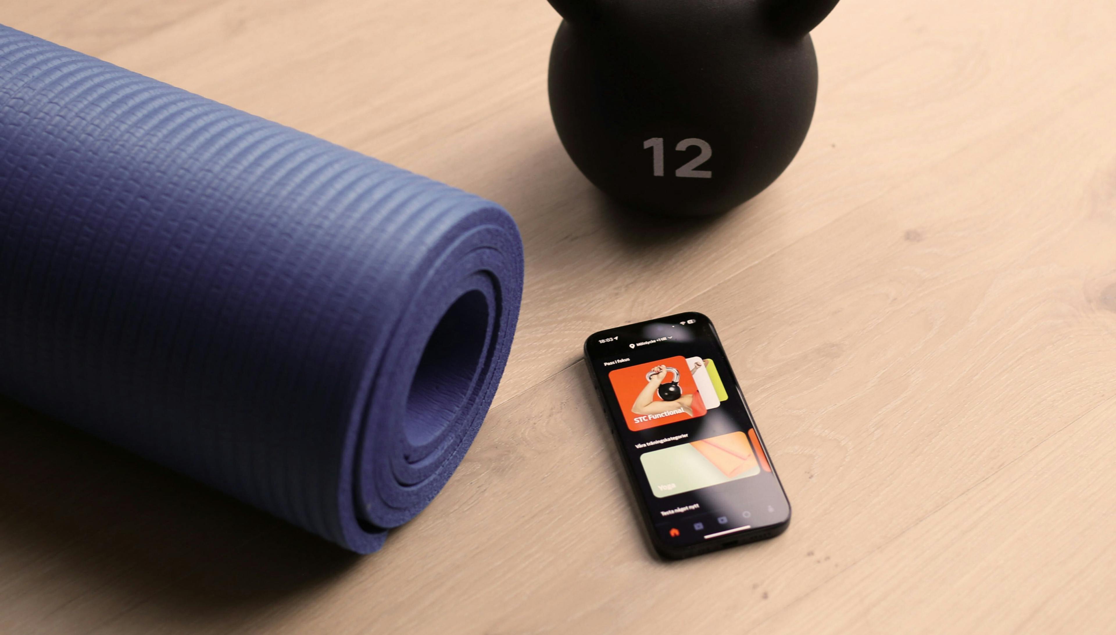 Photo of STC app next to kettlebell